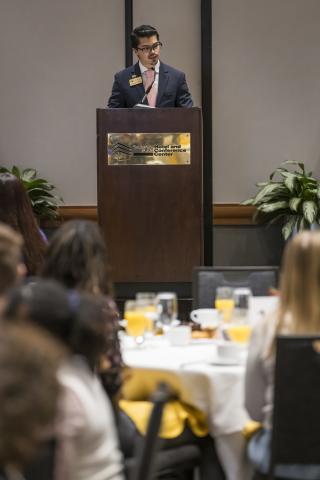 Student Andrés Robles Sotomayor speaking at a podium