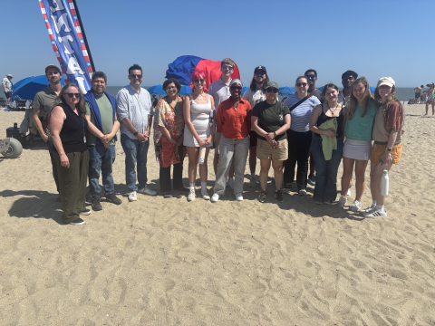 A group of people standing on a beach.