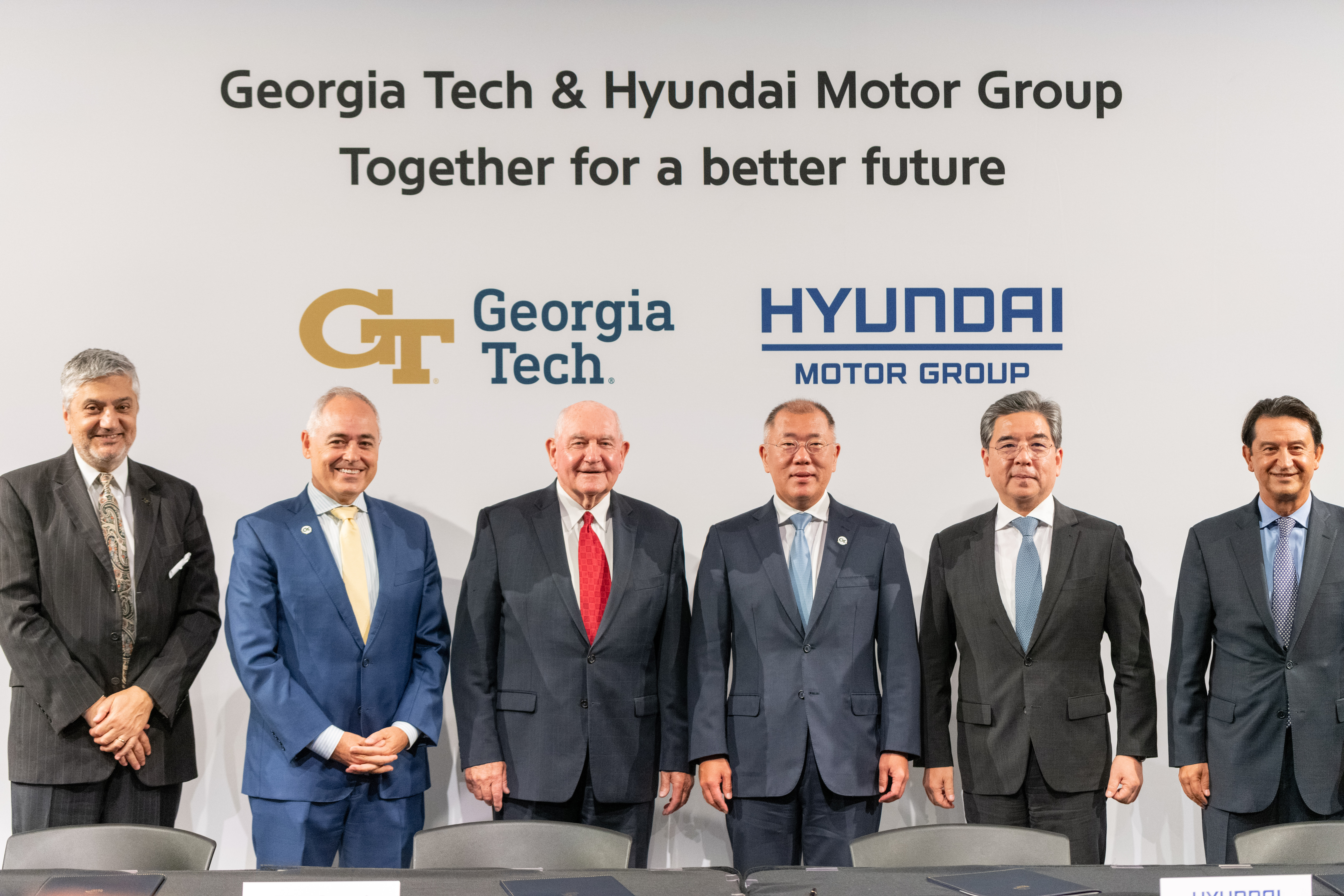 Georgia Tech and Hyundai leaders pose for a photo following the signing of the memorandum of understanding. From left to right: Executive Vice President for Research Chaouki Abdallah, Georgia Tech President Ángel Cabrera, University System of Georgia Chancellor Sonny Perdue, Executive Chairman of Hyundai Motor Company Euisun Chung, President and CEO Jay Chang, President and Global COO José Muñoz. 
