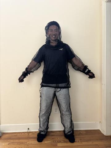 image of Chris Zuo in a mesh mosquito suit