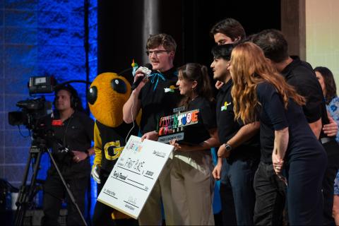 Team Hearo hold their prize after winning first place at the 2026 InVenture Prize competition.