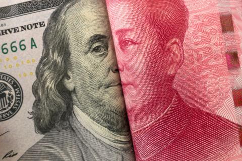 America dollar and Yuan banknote with USA and China flags.