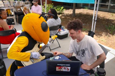 Buzz playing the guitar
