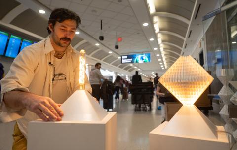Samuel Thurman installs digitally designed and fabricated lamps in the Atlanta airport